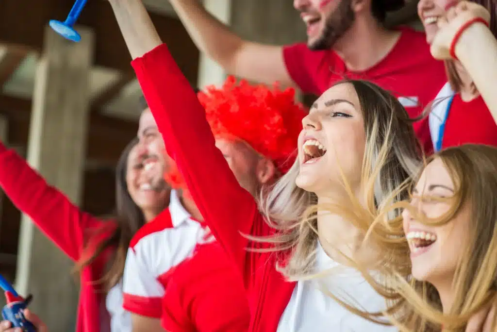 Fans cheering on sports team
