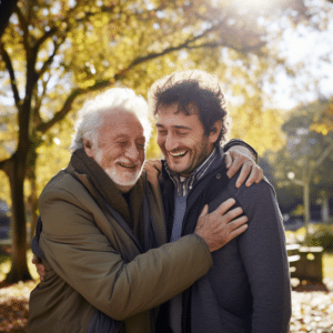 Elderly father and adult son embracing at a park in Alabama
