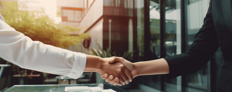 A woman shaking hands with her State Farm insurance agent