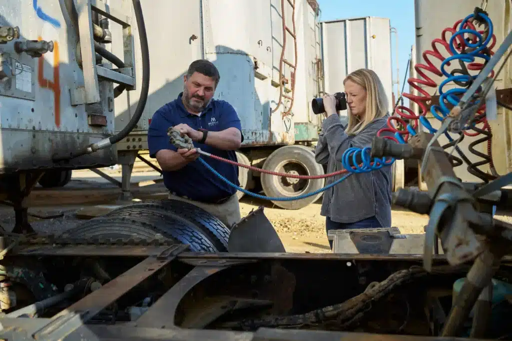 Steven Mezrano and Leah Johnson investigating a truck from a recent truck accident