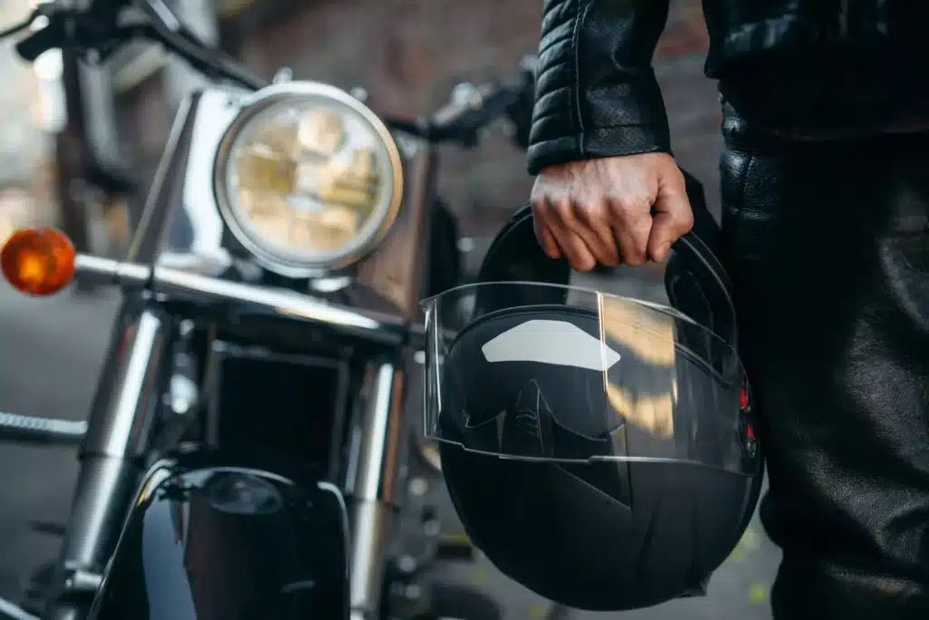 Closeup of motorcycle rider holding his helmet