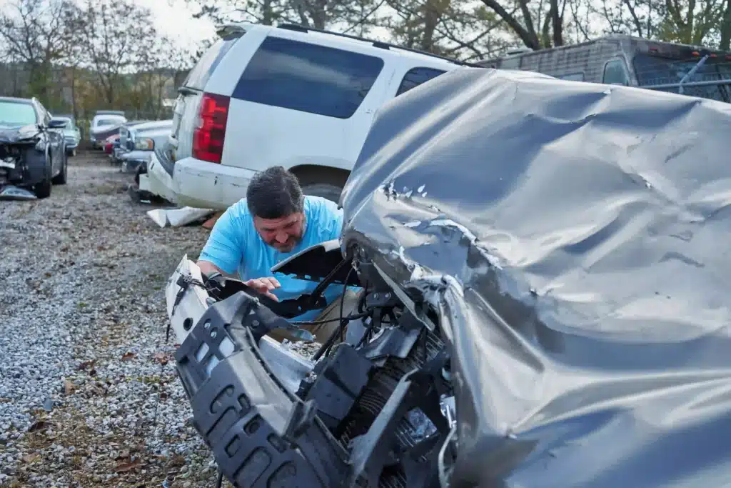 Steven Mezrano looking closely at a car from a recent car accident