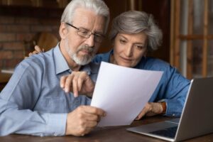 couples work through paperwork and read documents