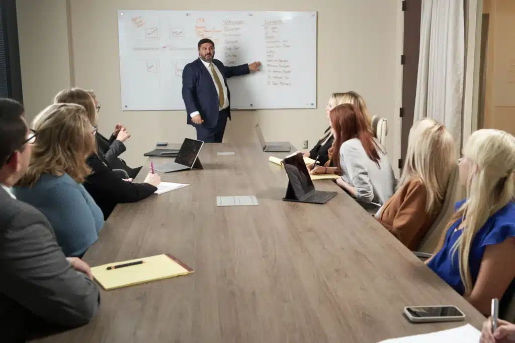 Steven Mezrano talking to employees in conference room