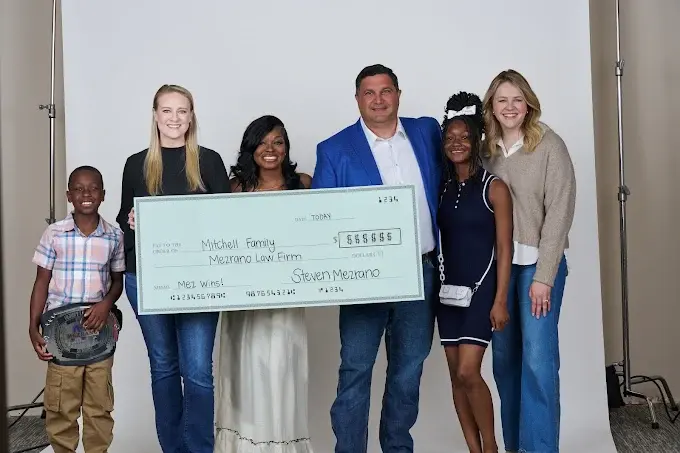 Mezrano® Law Firm presenting settlement check to client