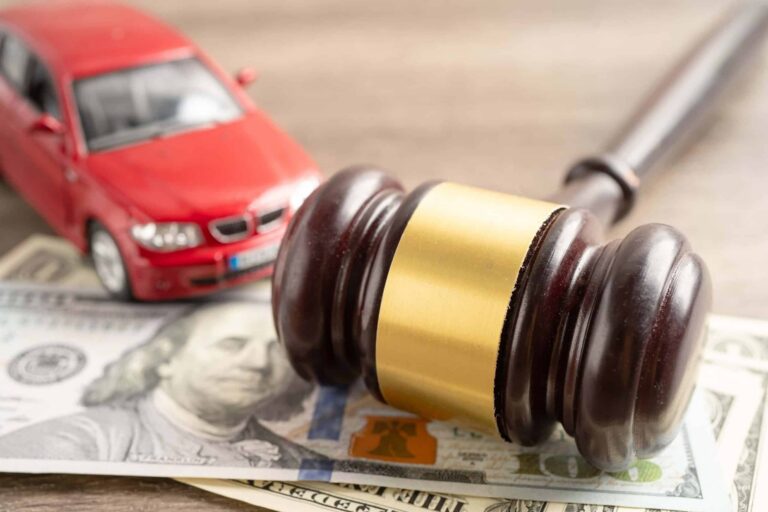 Judge's gavel and dollar bill with car accident