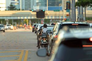 Motorcycle and car traffic at the intersection
