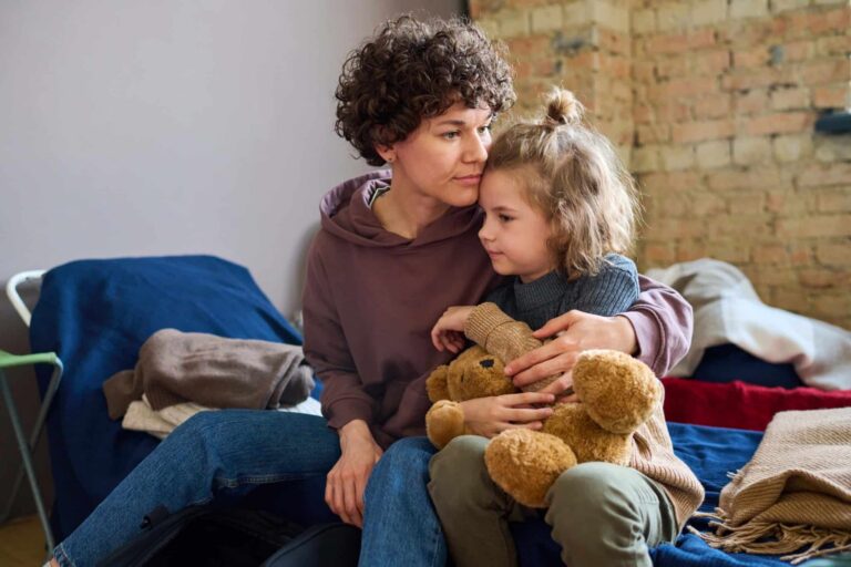 Young woman hugging her daughter