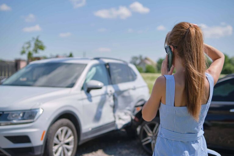 Female calling for emergency help after a car accident