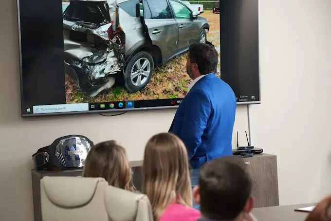 Steven Mezrano discussing a car accident case with staff members