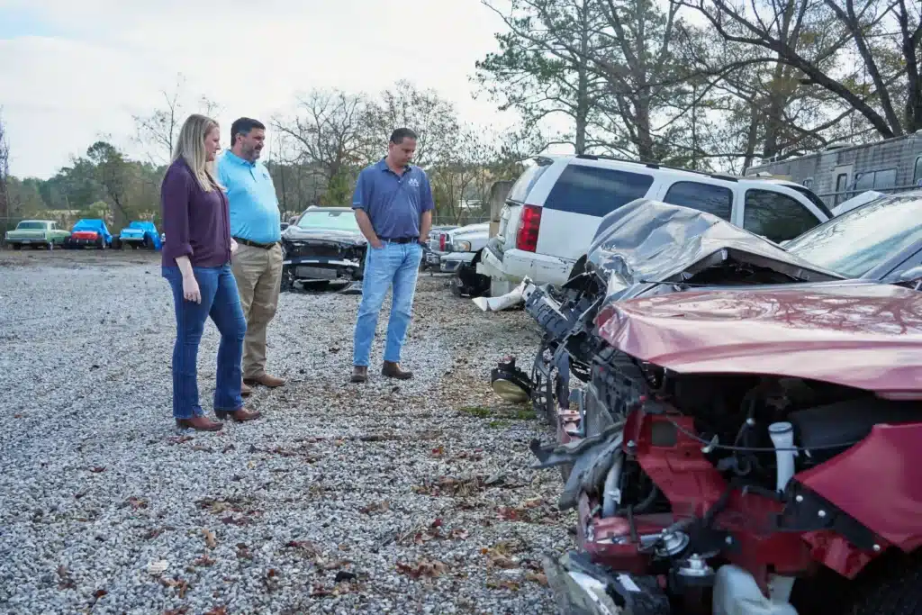 Attorney's from Mezrano® Law Firm looking at car damage from recent accident