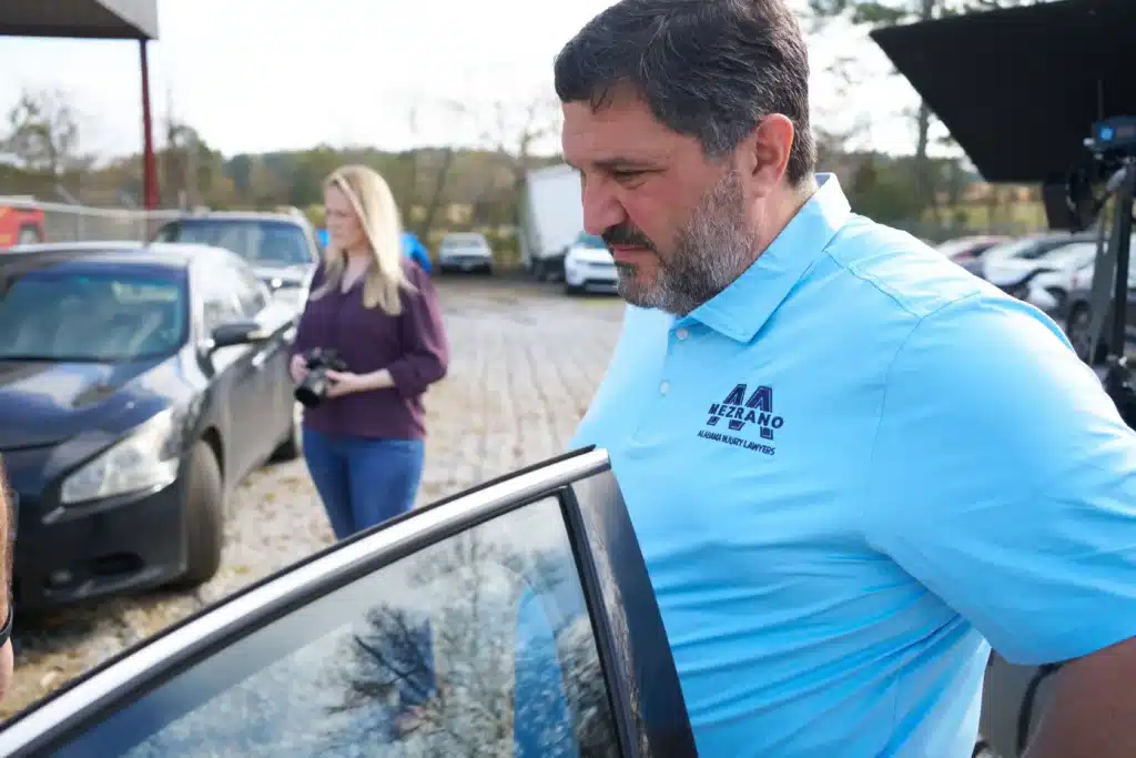 Steven Mezrano investigating damage at junk yard from a recent car accident