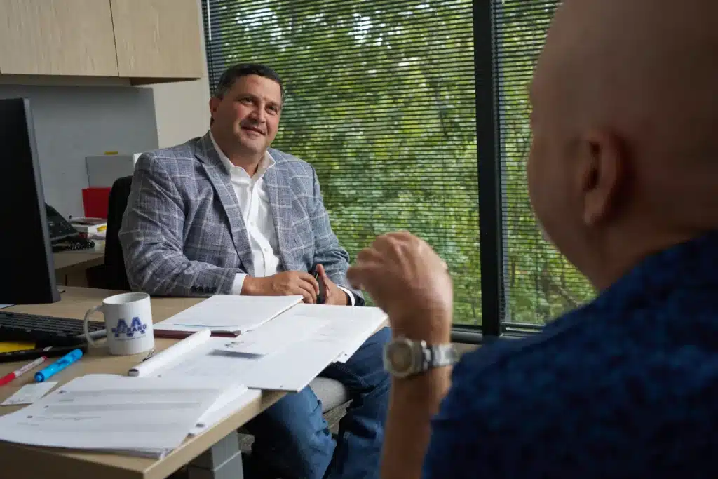 Steven Mezrano sitting with client in office