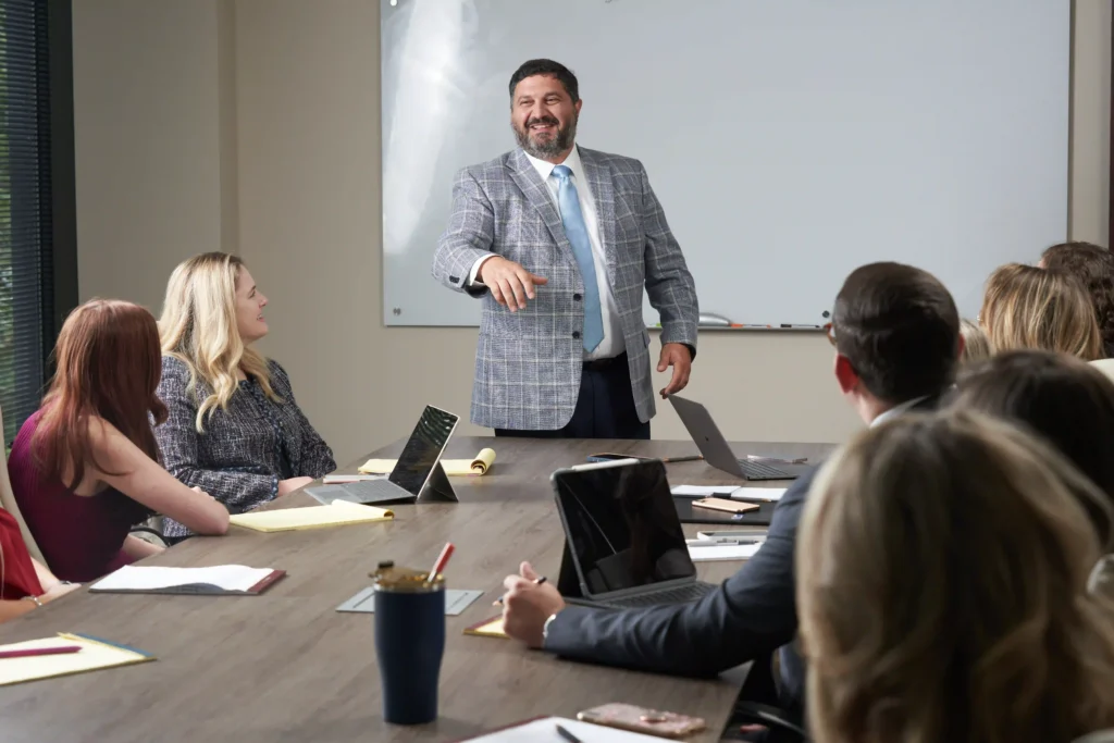 Steven Mezrano presenting details of case to staff members at Mezrano® Law Firm