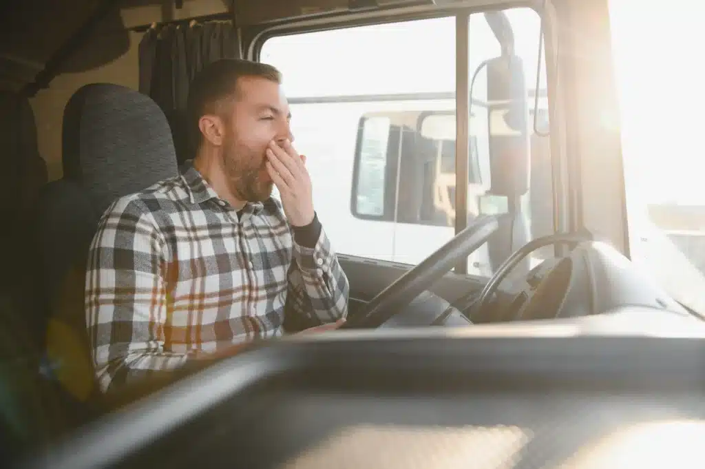 Truck driver yawning while driving